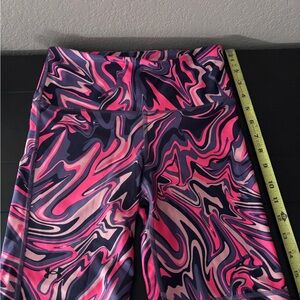 Under Armour Redish/orange, purple and Black Swirl Leggings-size small
